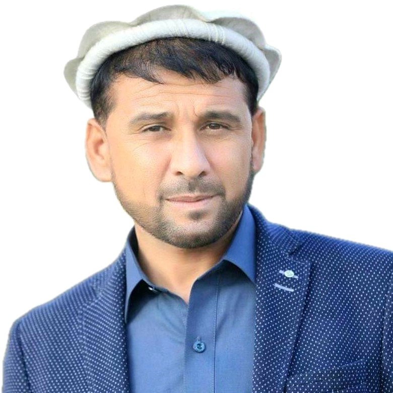 Engr. Azizullah Niazi, President of MECC, on site in high-visibility clothing on the Chawk Dand to Bagh Pol road in Kandahar province, with plant working behind him